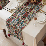 Decorative table runner with floral pattern on a set dining table.
