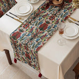 Decorative table runner with floral pattern on a set dining table.