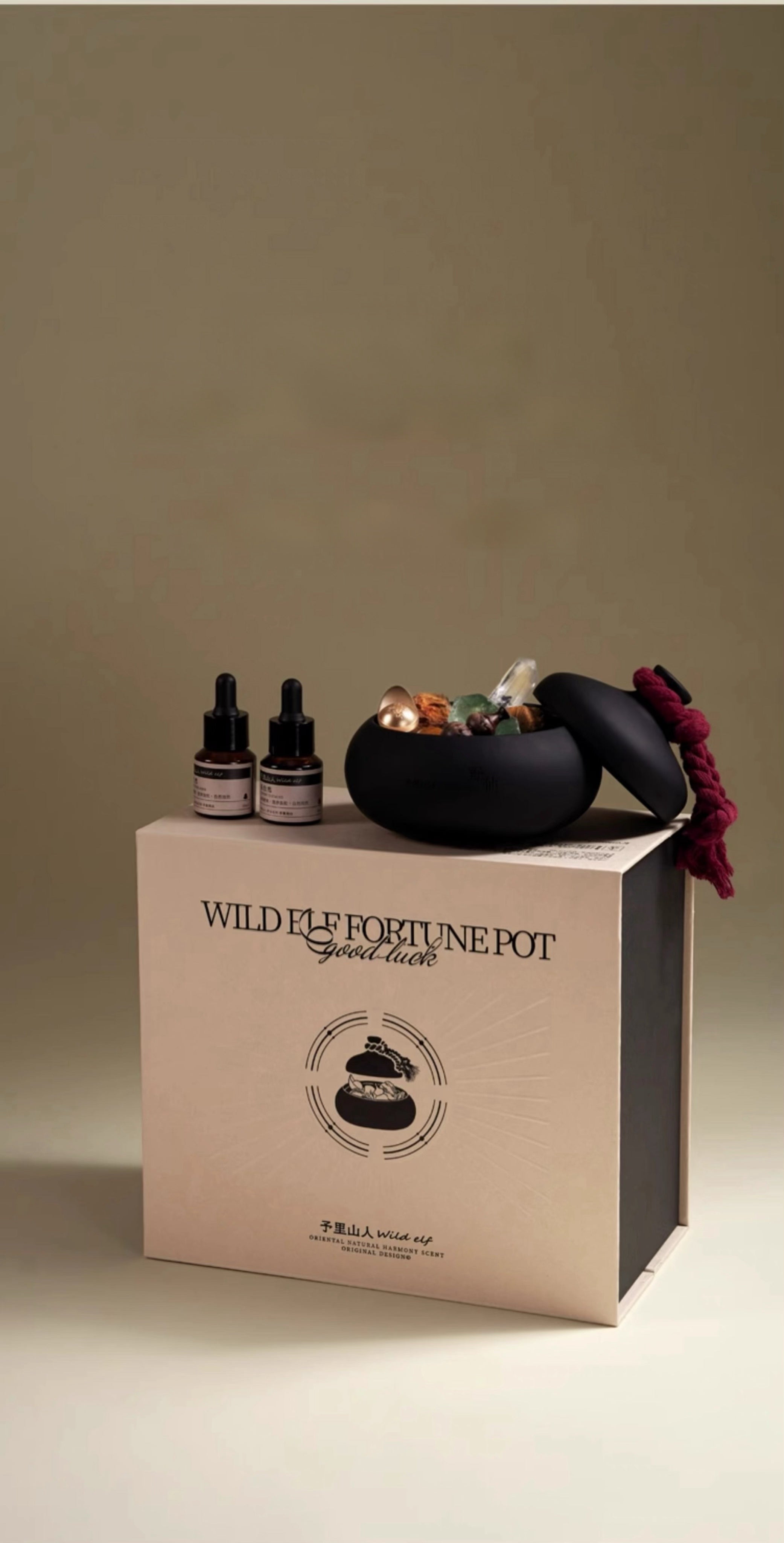 Product set with bottles and a pot on a branded box against a beige background