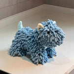 Blue plush toy resembling a creature on a light-colored floor.