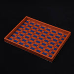 Wooden tray with blue checkered pattern on a black background