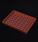 Wooden tray with blue checkered pattern on a black background