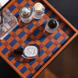 Set of nail polish bottles on a checkered wooden tray