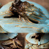 Decorative ceramic piece with fish design on a textured surface