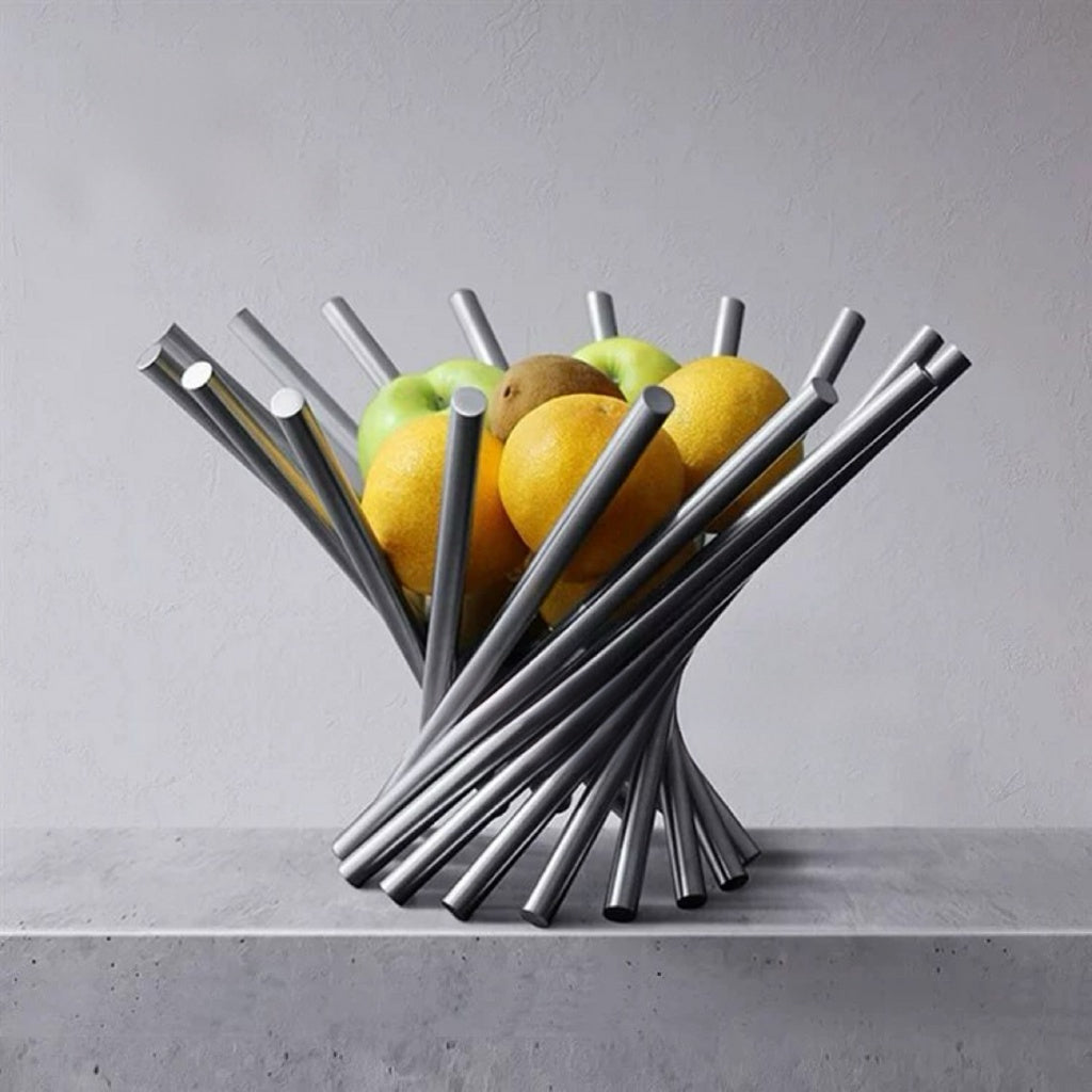Modern metal fruit basket with fruits on a gray surface and background