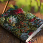 Decorative notebook with floral pattern on a wooden surface