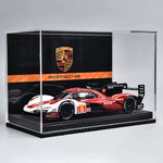 Model race car in a Porsche display case with the Porsche logo.