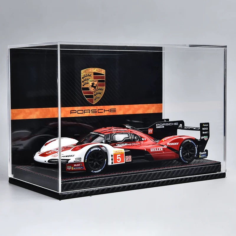 Model race car in a Porsche display case with the Porsche logo.