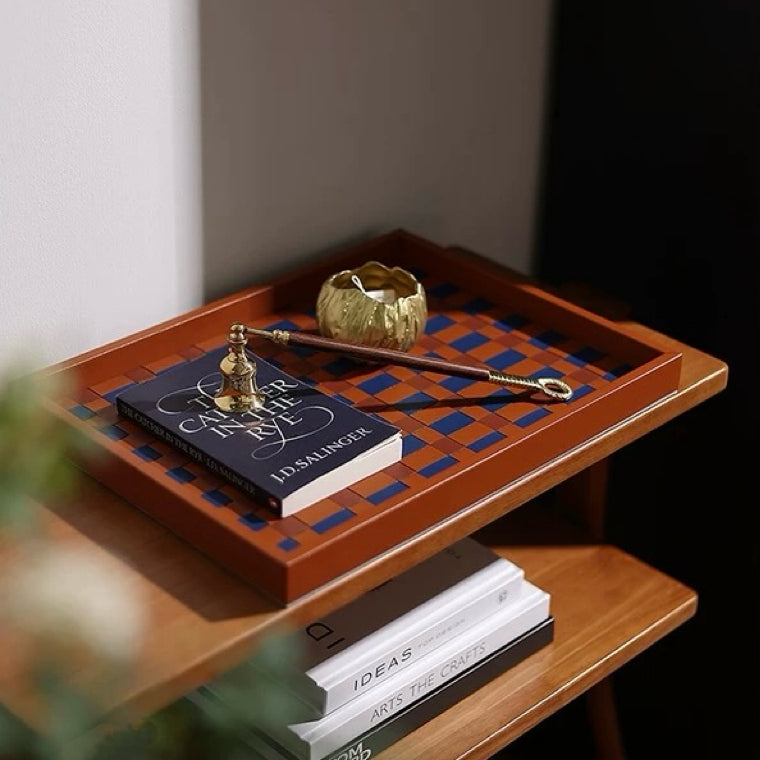 Wooden tray with decorative items on a wooden surface