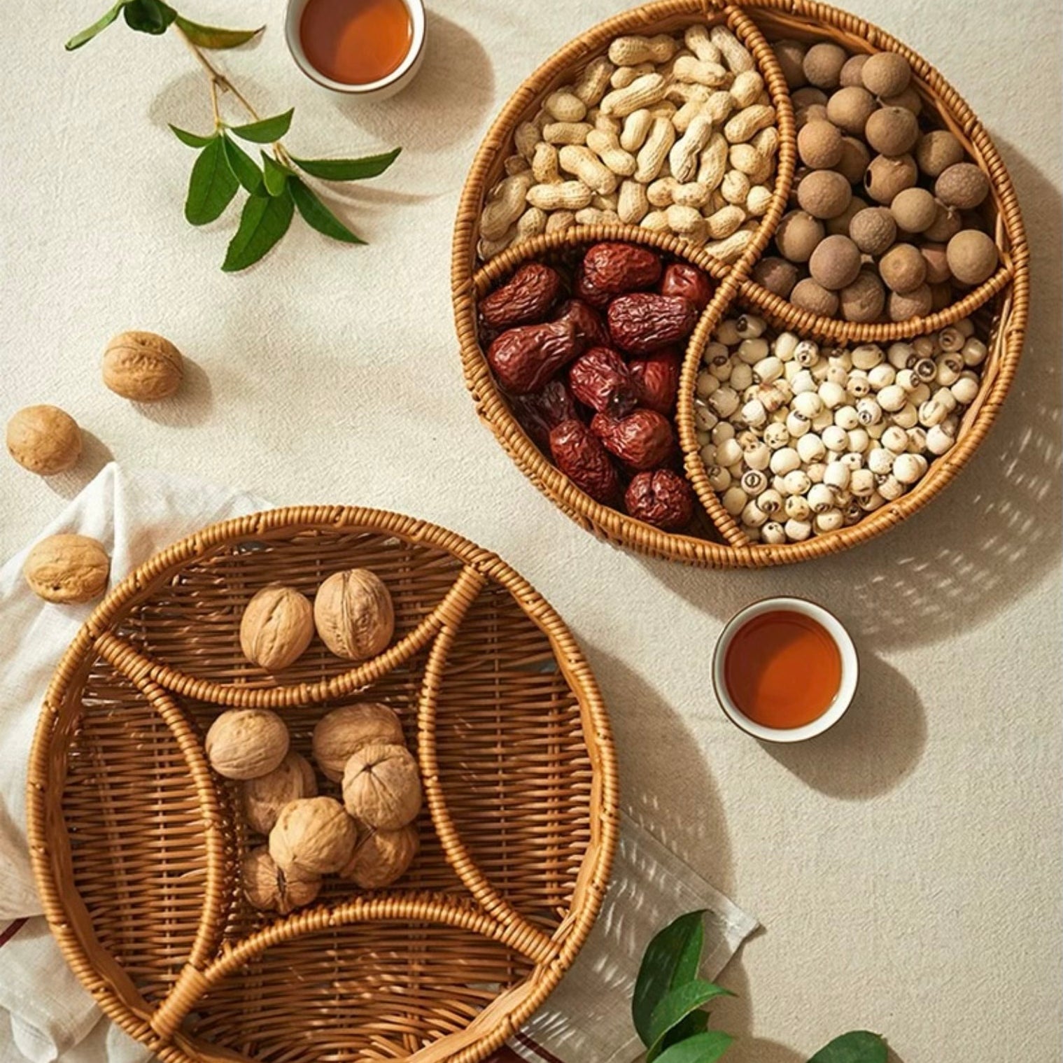 Two woven baskets filled with various nuts and dried fruits on a light surface.