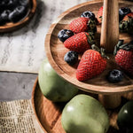 Wooden plate with strawberries and blueberries on a rustic surface