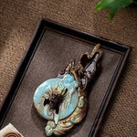 Decorative keychain with intricate design on a brown textured surface