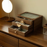 Wooden jewelry box with drawers on a wooden surface