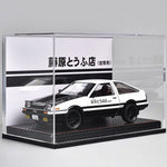 Model car in a clear display case with Japanese text on the background