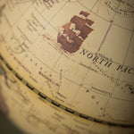 Close-up of a vintage-style globe focusing on the North Pacific region.