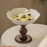 Decorative white bowl with a brown base on a table