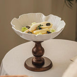 Decorative white bowl with a brown base on a table