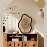 Wooden cabinet with a decorative clock on a neutral wall