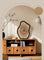 Wooden cabinet with a decorative clock on a neutral wall