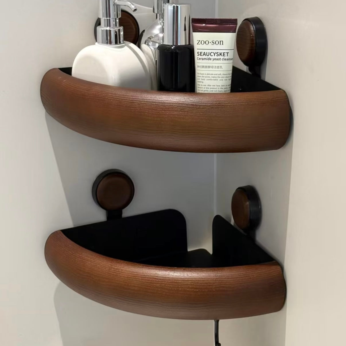 Wooden shelf with bathroom products against a white wall