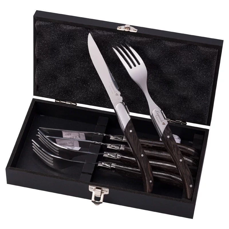 Set of cutlery including knives and forks in a black case on a white background