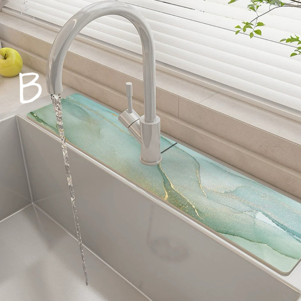 Modern kitchen sink with a white faucet and greenish countertop.