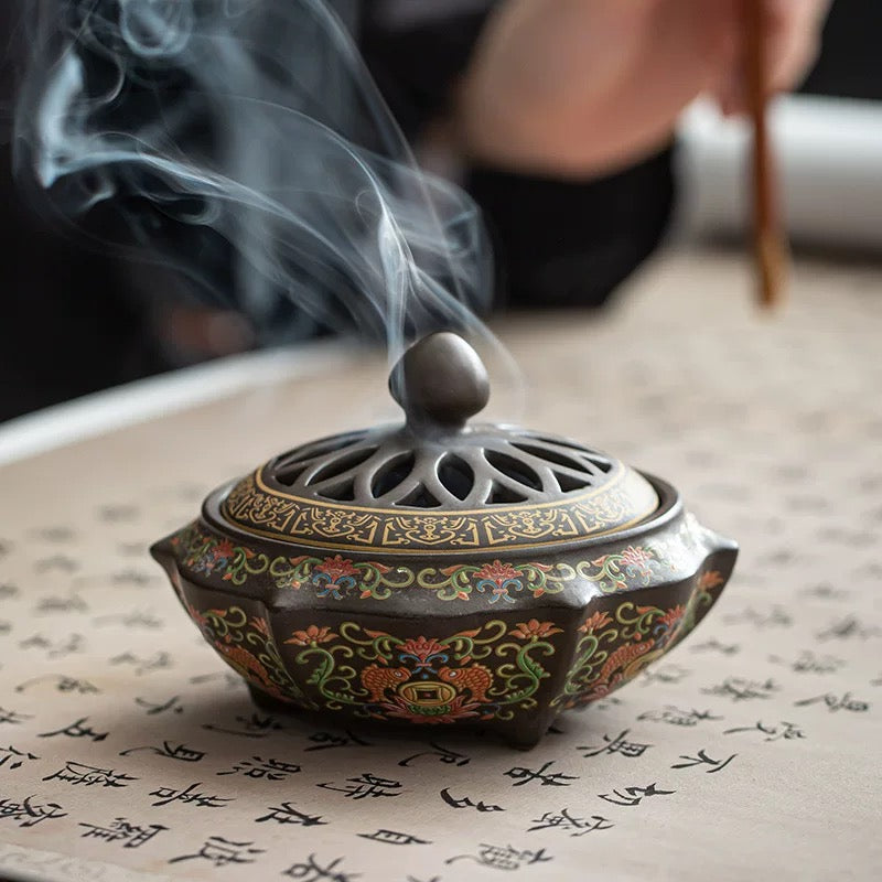 Decorative incense burner with smoke on a surface with text