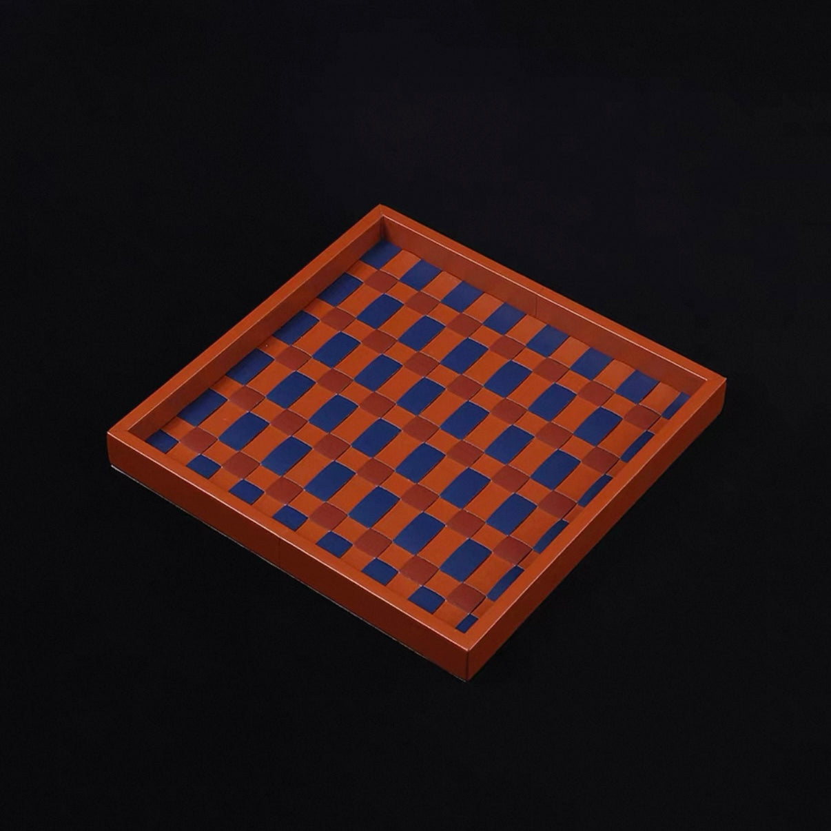 Wooden checkers board with alternating brown and blue squares on a black background