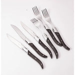 Set of knives and forks with wooden handles on a white background