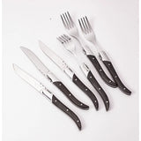 Set of knives and forks with wooden handles on a white background