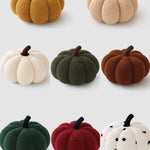 Set of colorful pumpkin-shaped plush toys on a white background