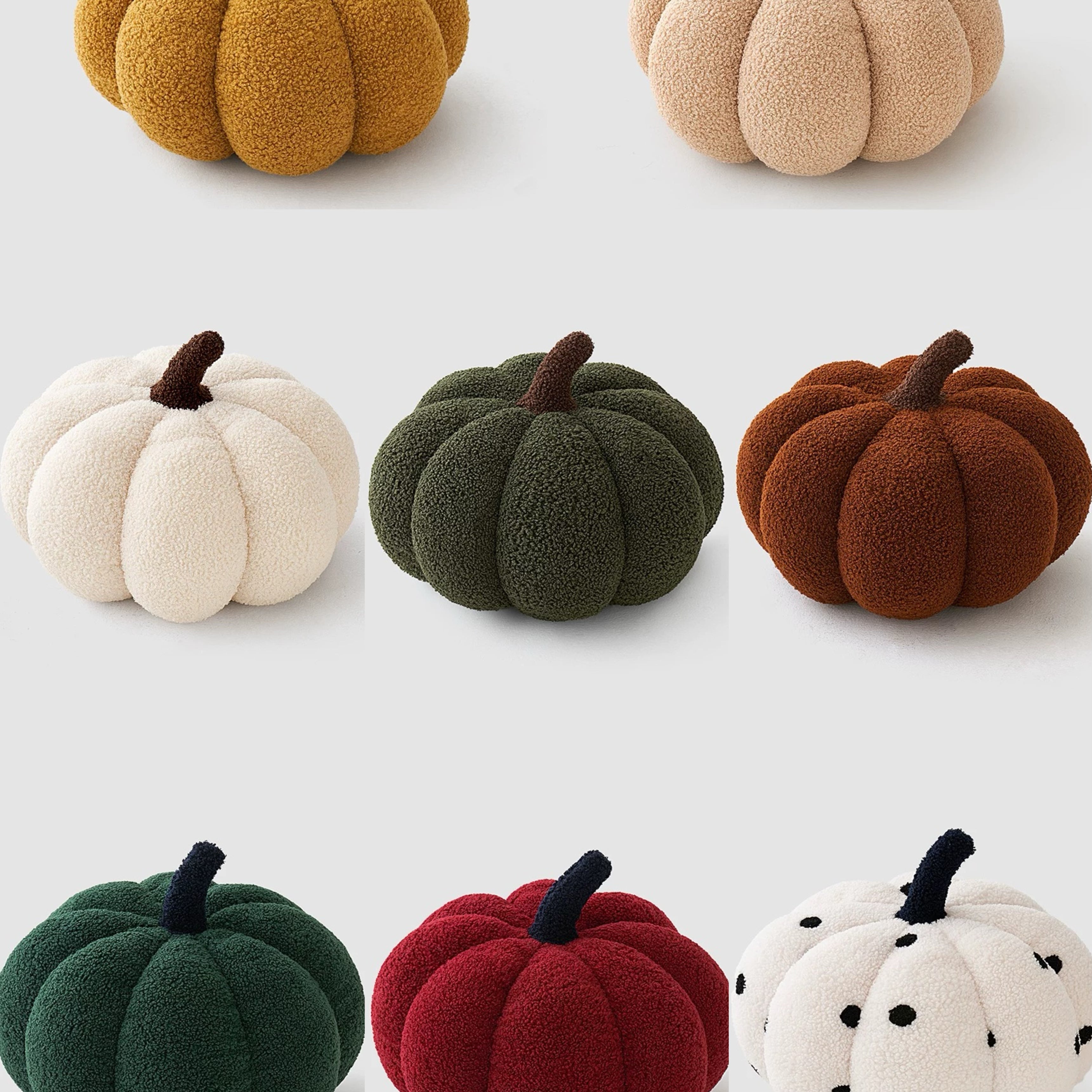 Set of colorful pumpkin-shaped plush toys on a white background