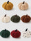 Set of colorful pumpkin-shaped plush toys on a white background