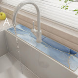 Kitchen sink with a modern faucet and running  blue water, set against a neutral background.