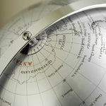 Close-up of a vintage-style globe with detailed map and compass rose.