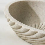 Close-up of a textured ceramic bowl on a white background