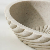 Close-up of a textured ceramic bowl on a white background