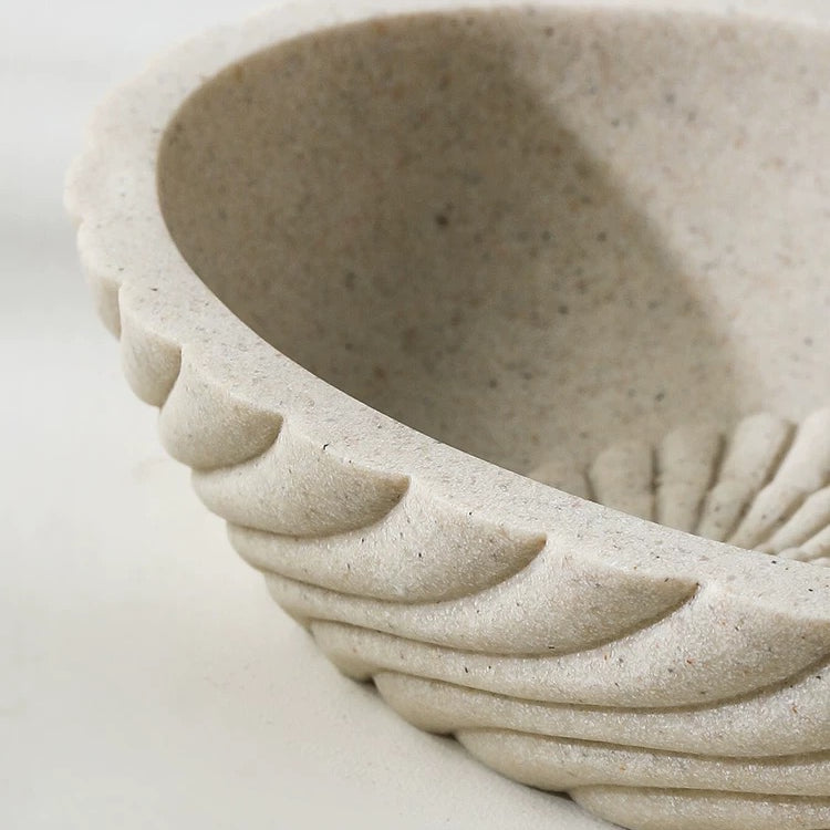 Close-up of a textured ceramic bowl on a white background