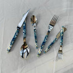 Set of floral-patterned cutlery on a light gray background