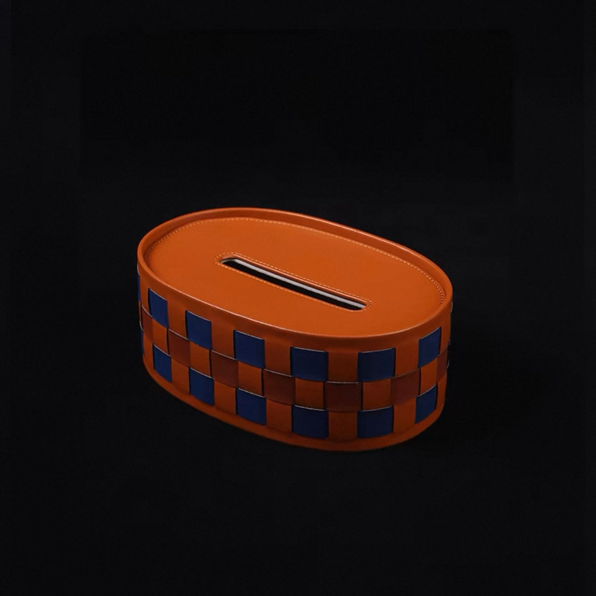 Brown woven tissue box with a checkered pattern on a black background