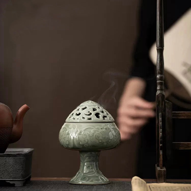 Decorative incense burner on a wooden surface with a blurred background