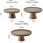 Three wooden cake stands with measurements and weights on a white background