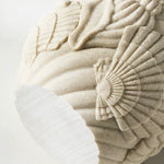 Decorative stone ball with intricate carvings on a light background