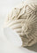 Decorative stone ball with intricate carvings on a light background