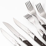Set of silver cutlery with wooden handles on a white background