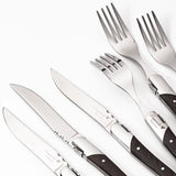 Set of silver cutlery with wooden handles on a white background