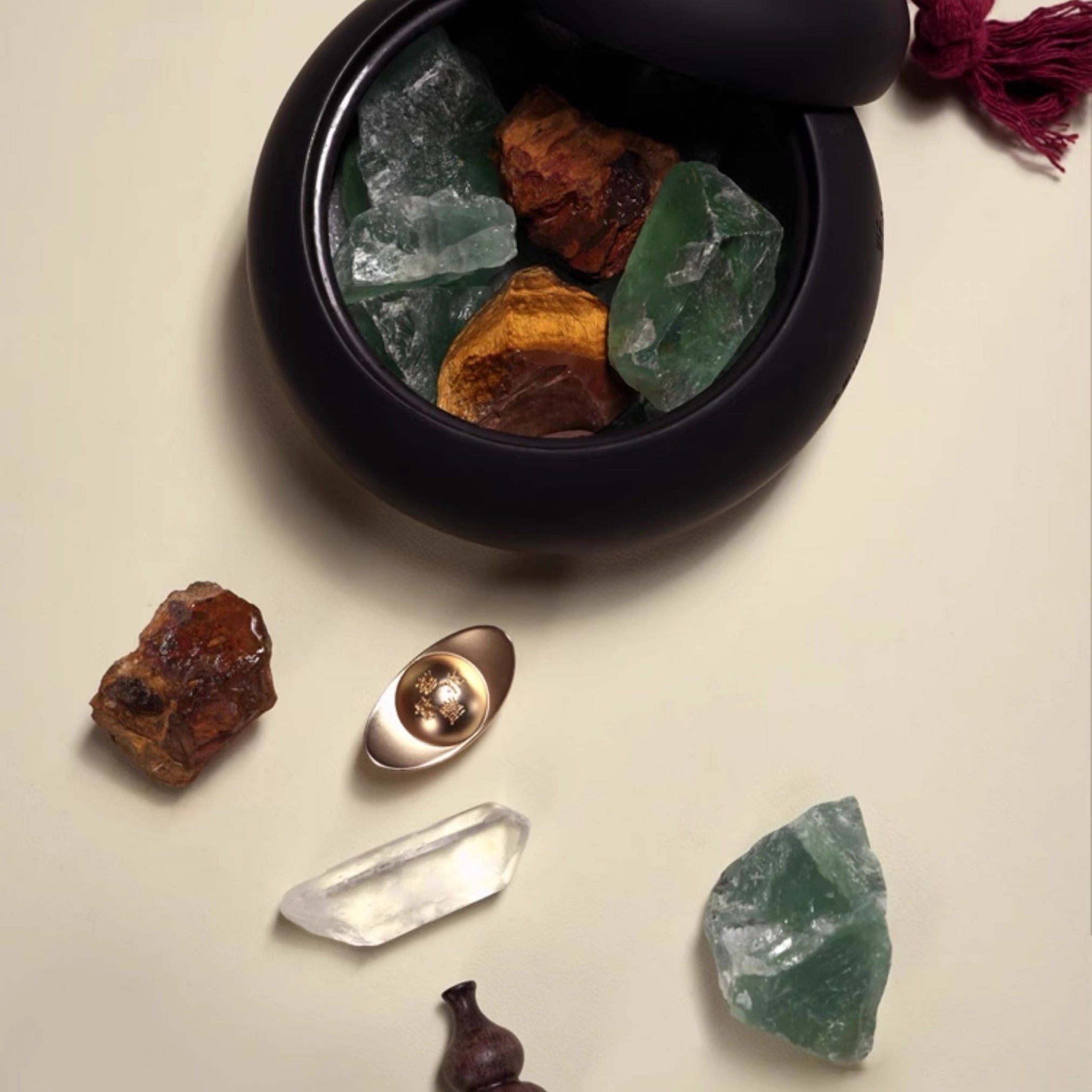 Black container with crystals on a beige background