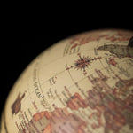 Close-up of a vintage-style globe with detailed map and compass rose.