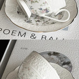 White floral teacup and saucer on a textured surface with text overlay