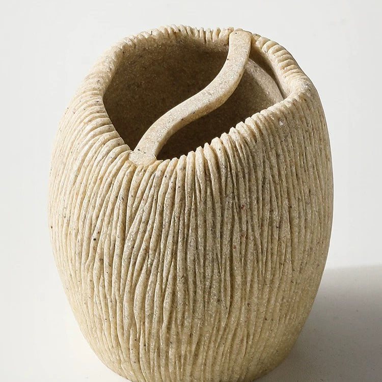 Textured ceramic vase on a white background